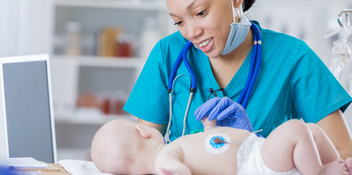 Boston Children's Hospital nurse checking a baby's vital signs.